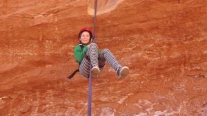 person canyoneering wearing a helmet